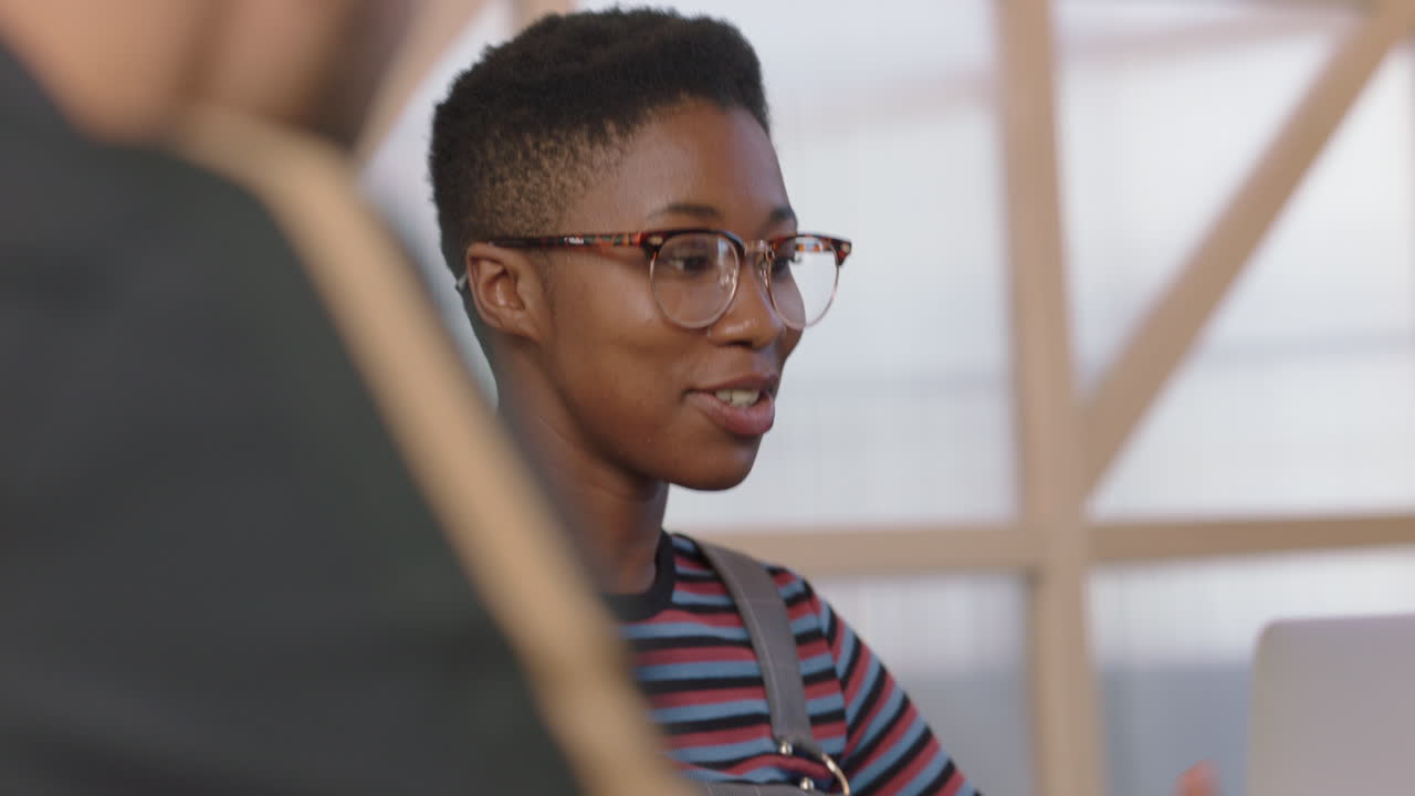 close up young business people meeting african american client sharing creative ideas enjoying conversation discussing startup company development strategy happy entrepreneurs in office interview