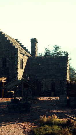 a ruined stone building in a medieval village