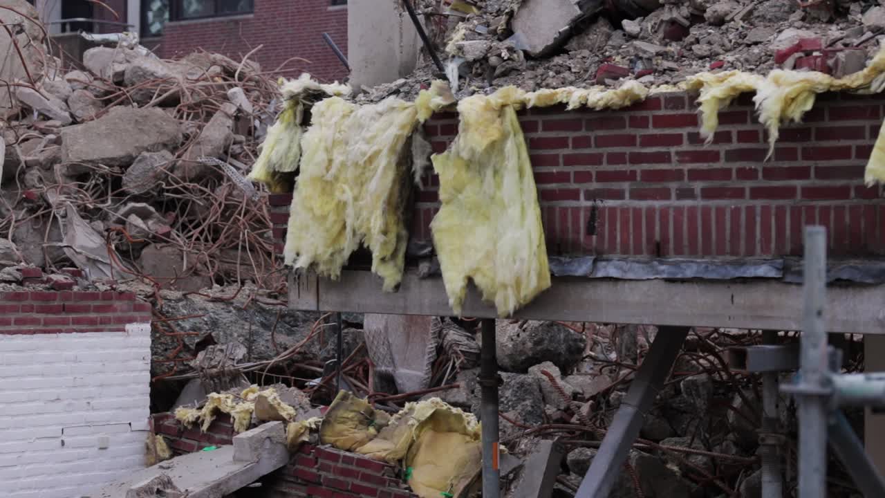 Some ripped out isolation foam waving in the winds, being left at a building site