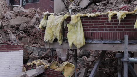 some ripped out isolation foam waving in the winds, being left at a building site