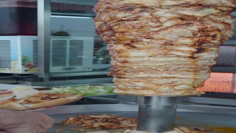 close up of a shawarma being prepared on a rotisserie