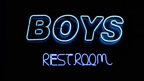 boys restroom bathroom blue neon sign on wall straight on wide angled shot as camera slowly zooms in with a whip pan transition - in cinema 4k