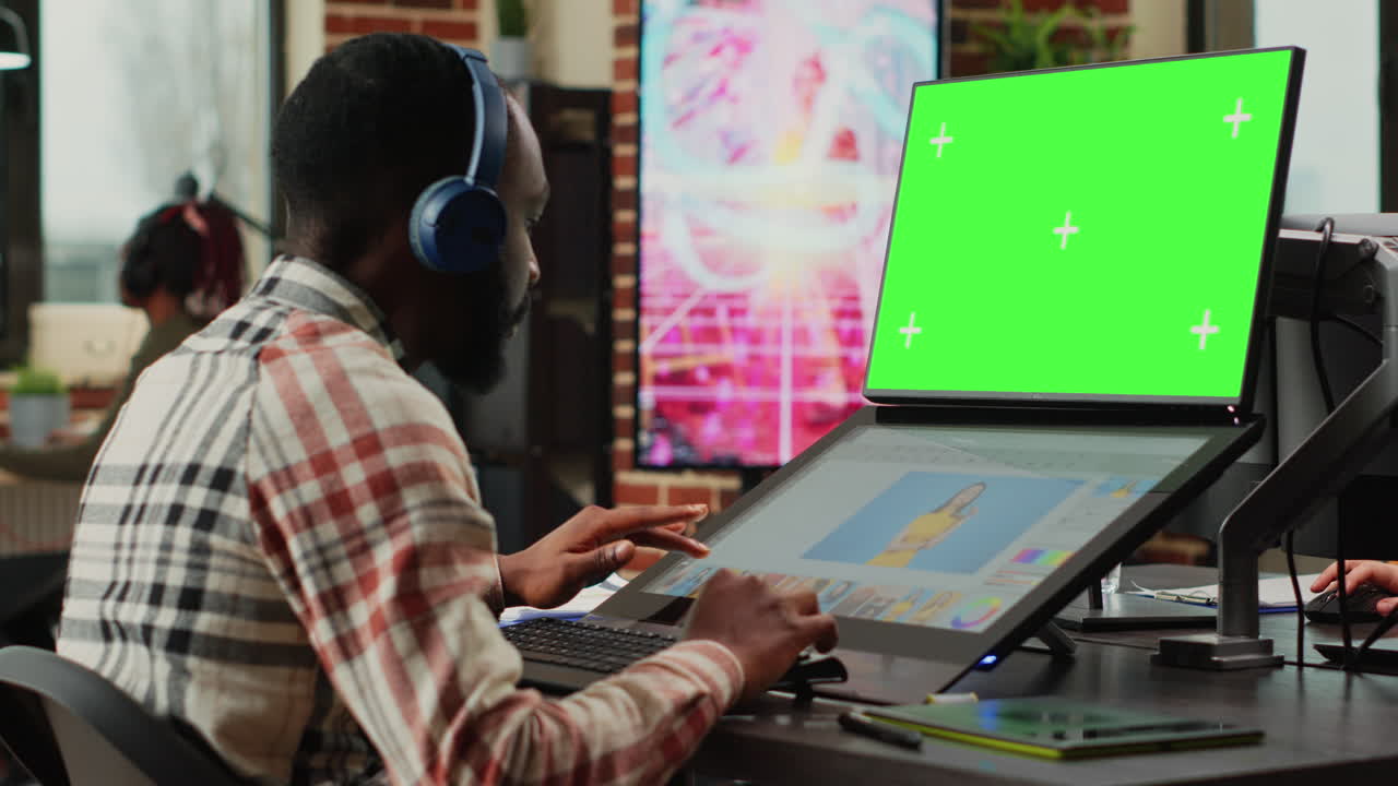 African american editor using greenscreen template on monitor