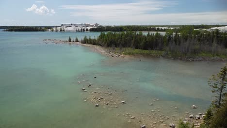 Aerial-Ascent-of-Lakeside-Quarry,-Cedarville,-Michigan