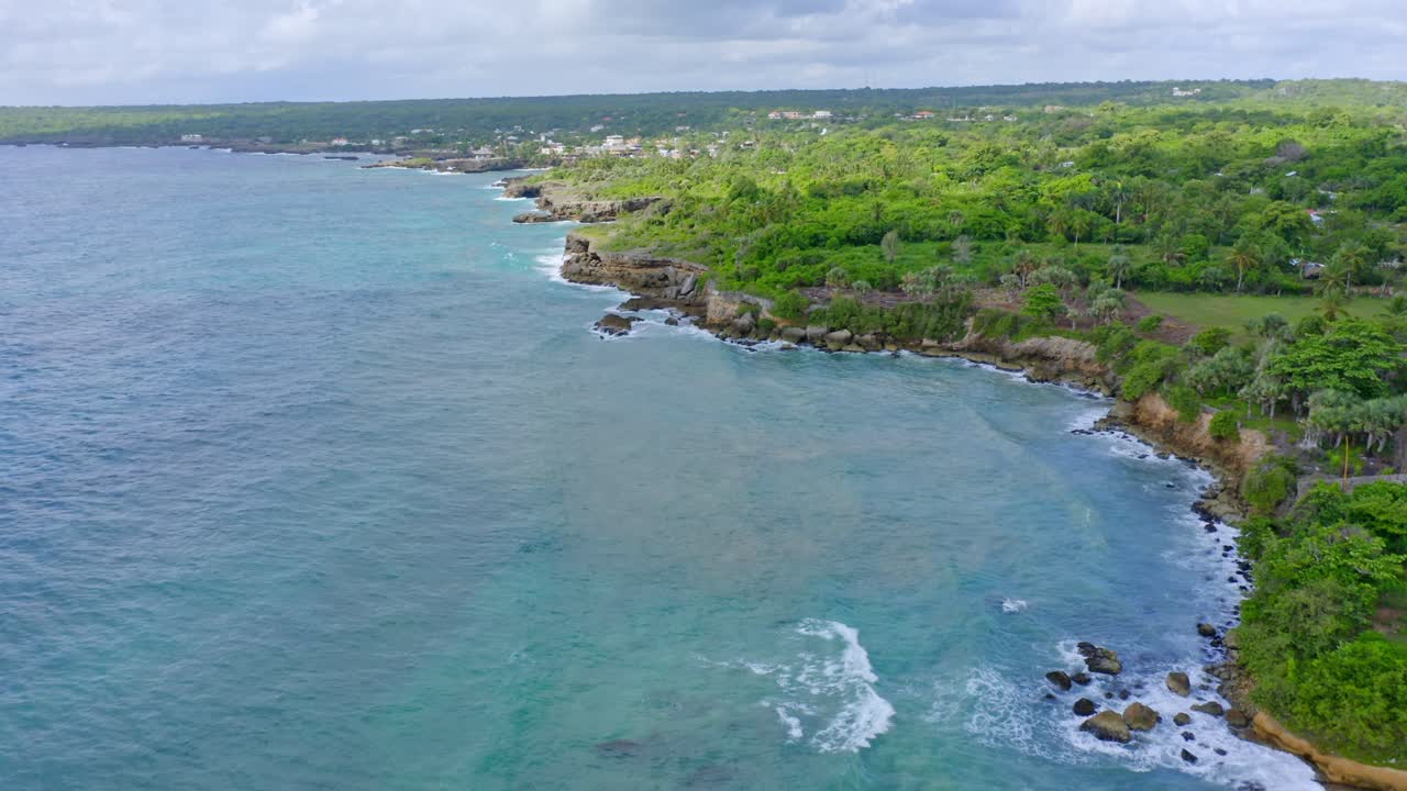 Costa caraibica rocciosa con lussureggiante vegetazione tropicale.