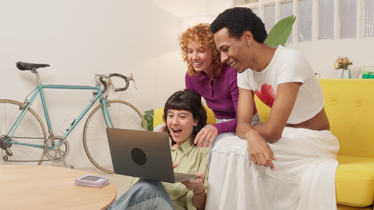 Friends laughing at laptop