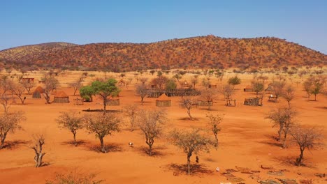 low aerial over a himba african tribal settlement and family compound in northern namibia africa