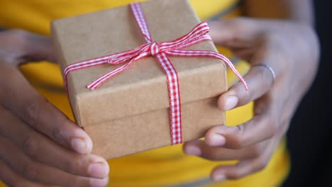 manos sosteniendo una caja de regalos