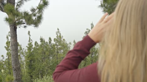 Woman-yelling-on-top-of-the-mountain,-handheld-closeup