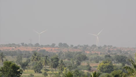 wind power plant at outskirts of the city in green lush vegetation