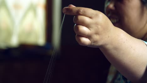 hand holding silk fibres