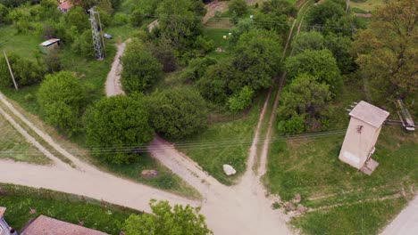 Pedestal-drone-shot-moving-down-on-the-village-of-Tsarichina-Hole,-a-remote-countryside-known-for-some-extraterrestrial-sightings-in-Bulgaria