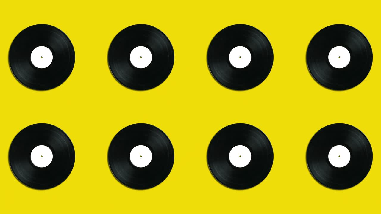 Yellow background with vintage vinyl disks in geometric pattern. Minimal motion graphics music looped animated concept