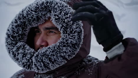 person in a winter coat in snowy landscape