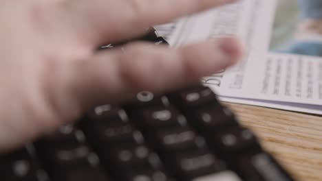 Person-Using-Keyboard-Next-To-Newspaper-Headline-Discussing-Strike-Negotiations-In-Trade-Union-Dispute