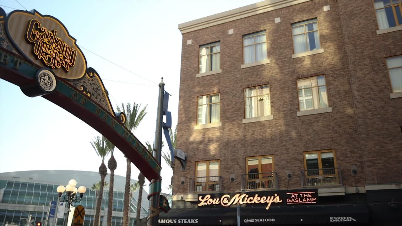 4K video captures the Gaslamp Quarter San Diego Sign, panning to Lou and Mickey's restaurant on September 26, 2023, with the Convention Center in the backdrop
