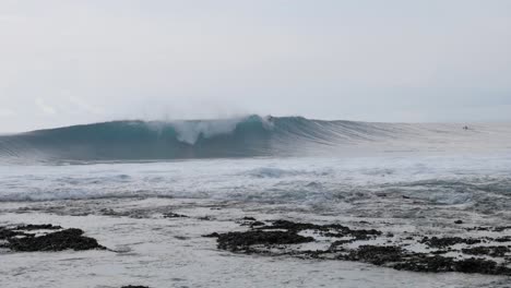 ultra slow motion shot of surfer surfing a wave at asu island, north sumatra, indonesia