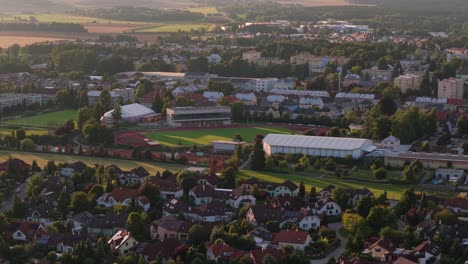 outdoor stadium offering sports activities for city residents. located among family houses in the suburbs. svitavy, czech republic. drone shot