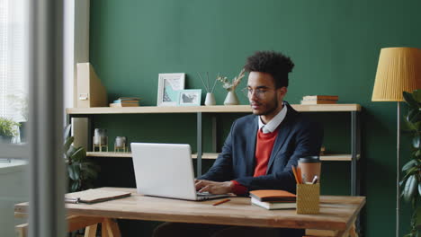 man working on laptop in office