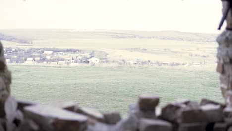 ruined wall with a view of a countryside village