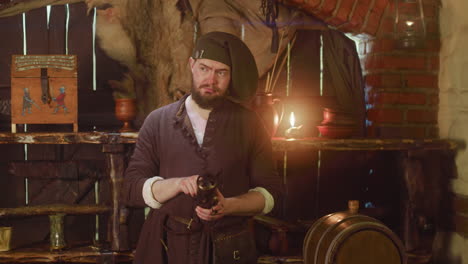 bearded keeper holds dry herbs for potion in store. serious seller hides dangerous ingredients in metal container in medieval tavern. magical shop