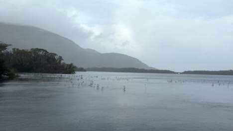 Muckross-Lake-during-a-rainy,-overcast-day-in-County-Kerry,-Ireland