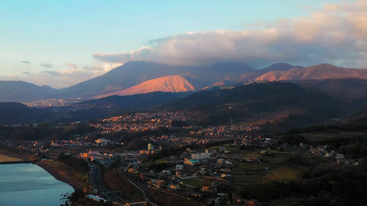 Aerial View of Japanese Village at Sunset with Mountains in Background