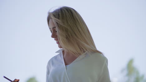 excited girl holding smartphone and walking outdoor