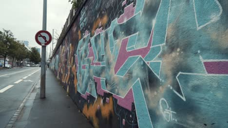 graffiti-covered wall on city street