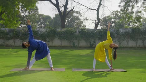 indian couple doing stretching and yoga