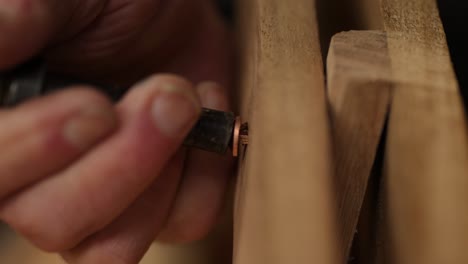 fastening rove on copper nail securing wood boat gunwale