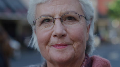 portrait of happy old ladt mature woman smiling outdoors in city at night