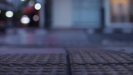 lane for helping blind people on pedestrian walk with blurry background of vehicles passing on the road