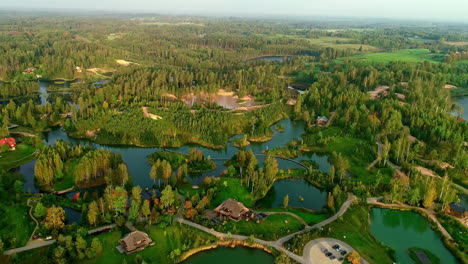 aerial dolly out revealing the enchanting village of amatciems between lakes in latvia