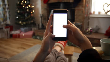 woman on line with mobile phone in room ready for christmas