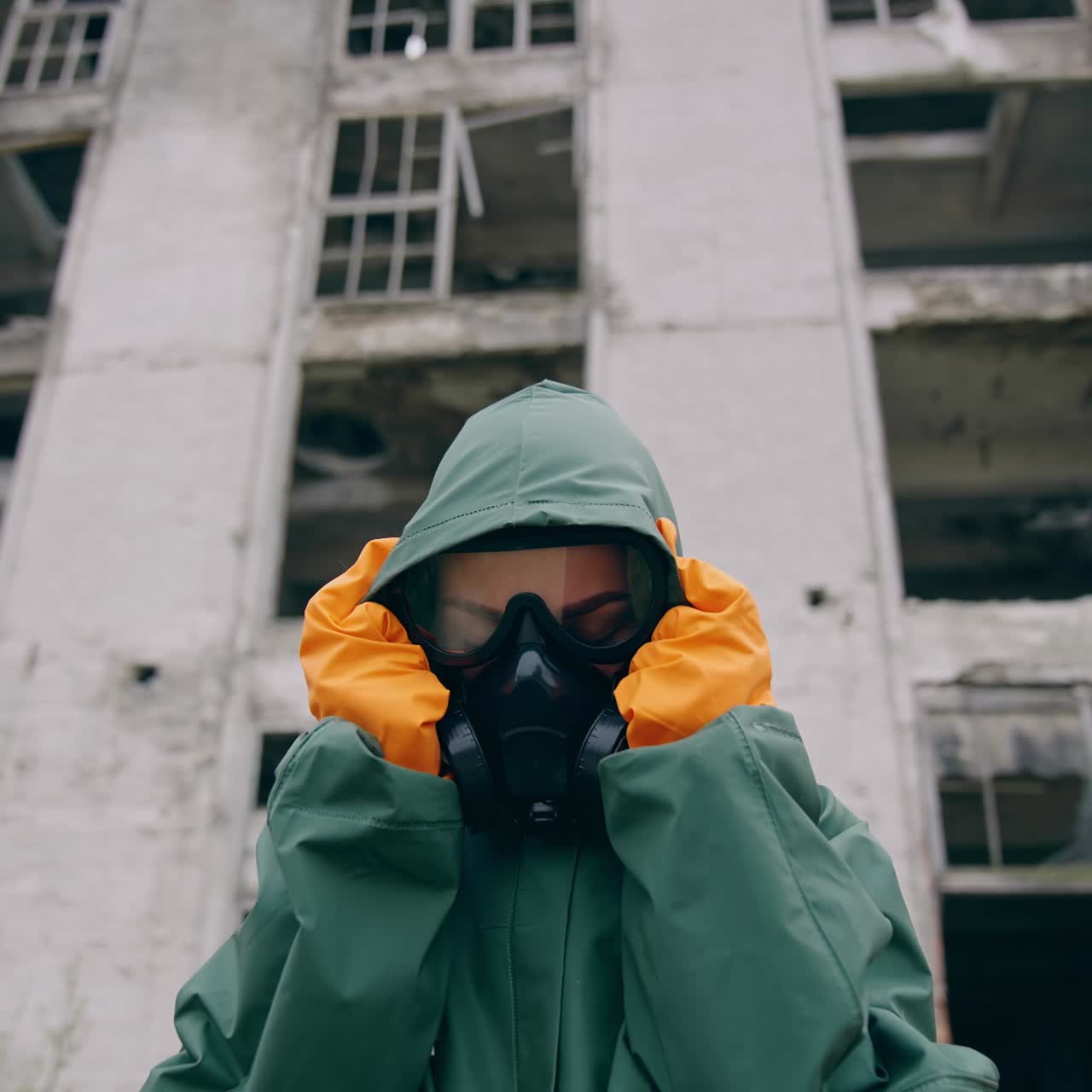 Man sitting on background of ruins. Stalker concept survivor after nuclear chemical war