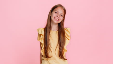 Child girl kid smiling brightly and showing thumbs up like gesture to express agreement or approval
