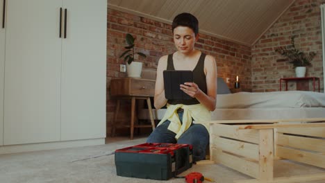 woman assembling wooden storage crate