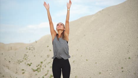 woman stretching in a desert landscape