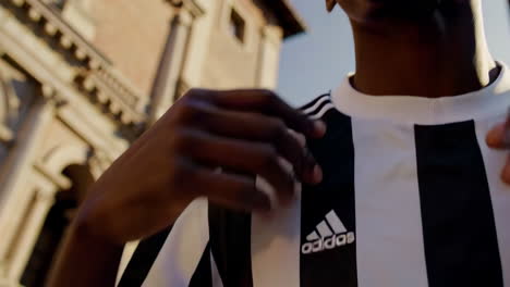 italian football player in front of architectural building