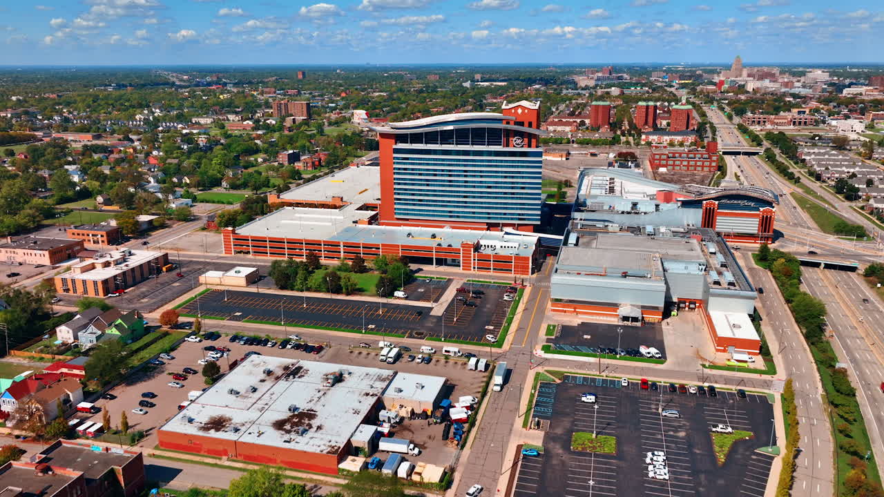 Detroit, USA, 28 July 2025: Approaching the building of Motor City Casino in Detroit, Michigan, USA. Green scenery of the city at backdrop