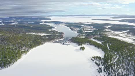 aerial view of frozen river and evergreen forests in northern europe