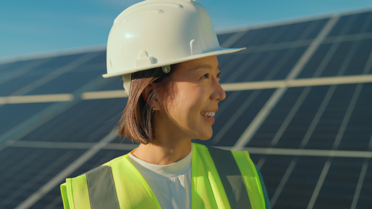 Woman in Safety Gear near Solar Panels