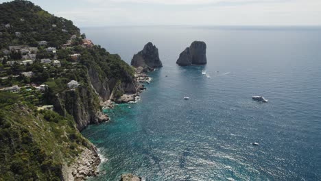 picturesque faraglioni and rugged coastline in capri, italy