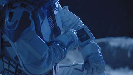 astronaut reviewing data on the moon