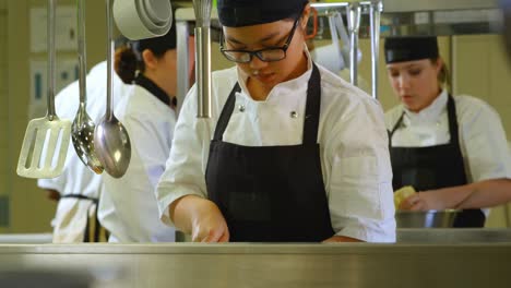 female chef working in kitchen 4k