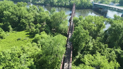 Norwottuck-Rail-Trail-Bridge-Along-The-Park-With-Green-Trees-Spanning-The-Connecticut-River-In-Northampton,-Massachusetts,-USA