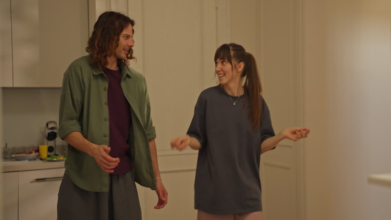 Two people dancing in a kitchen