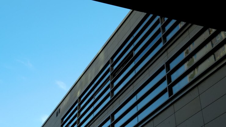 Esterno di un moderno edificio con lunghe finestre orizzontali in vetro in città.