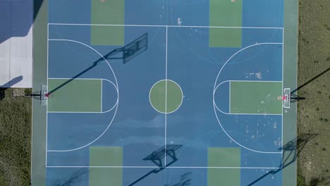 empty basketball courts, rising aerial top down view